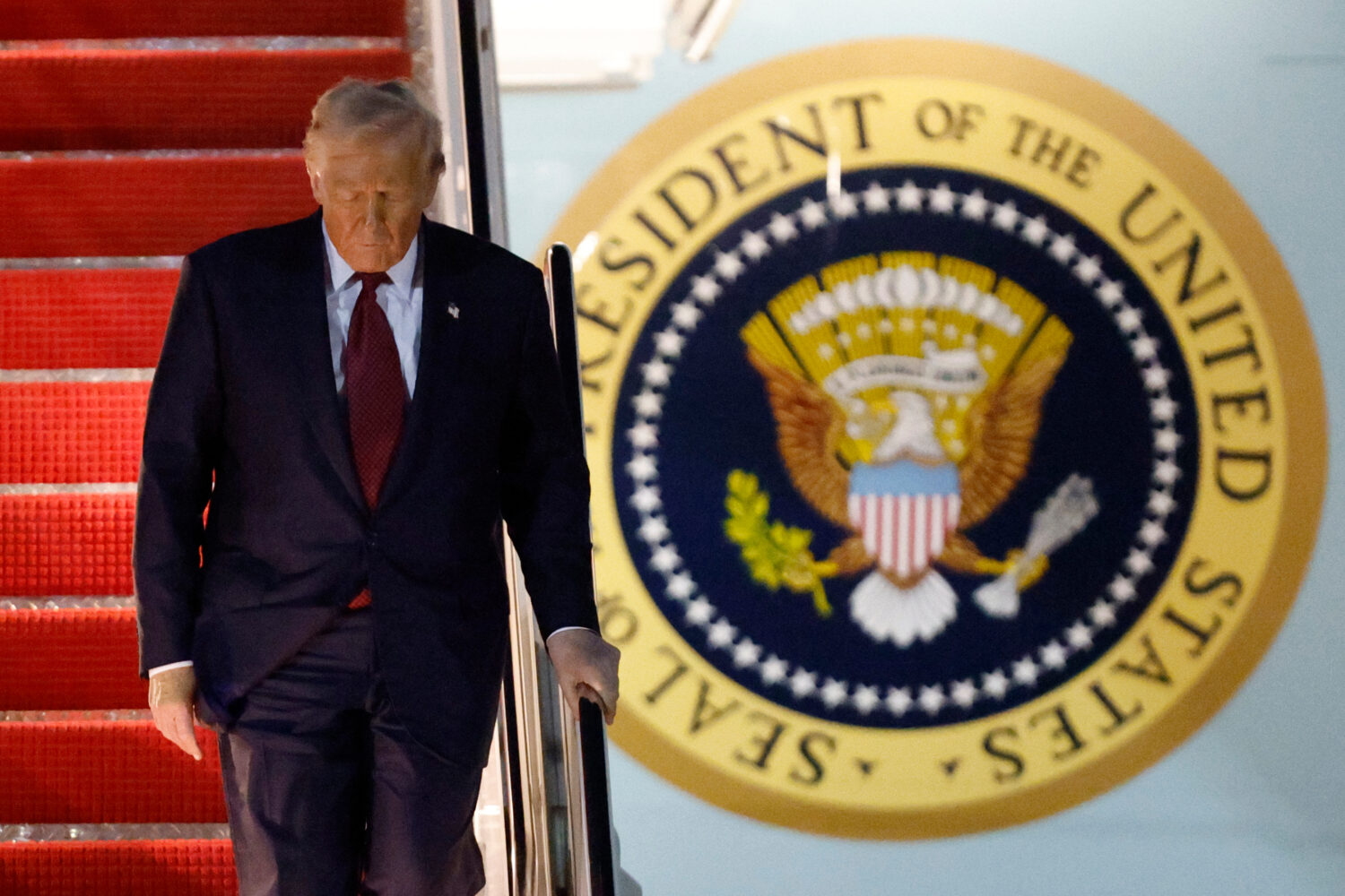 President Donald Trump walks down the stairs of Air Force One upon his arrival at Joint Base Andrew...