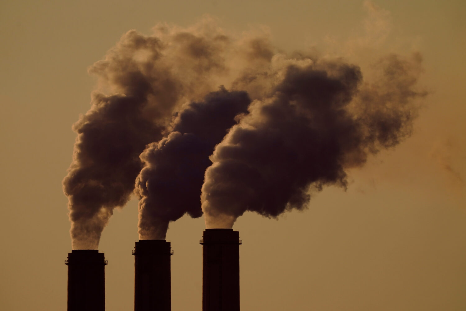 FILE - Emissions rise from the smokestacks at the Jeffrey Energy Center coal power plant as the sun...