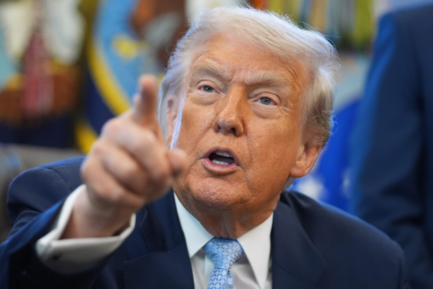 President Donald Trump answers questions from reporters during a meeting with the White House task ...
