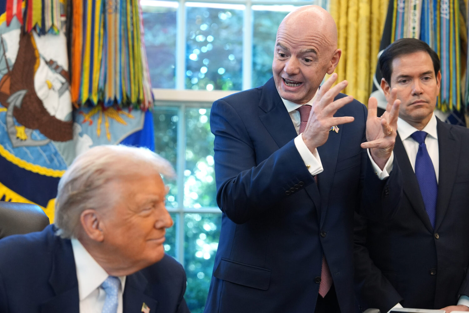 President Donald Trump and Secretary of State Marco Rubio listen as FIFA President Gianni Infantino...