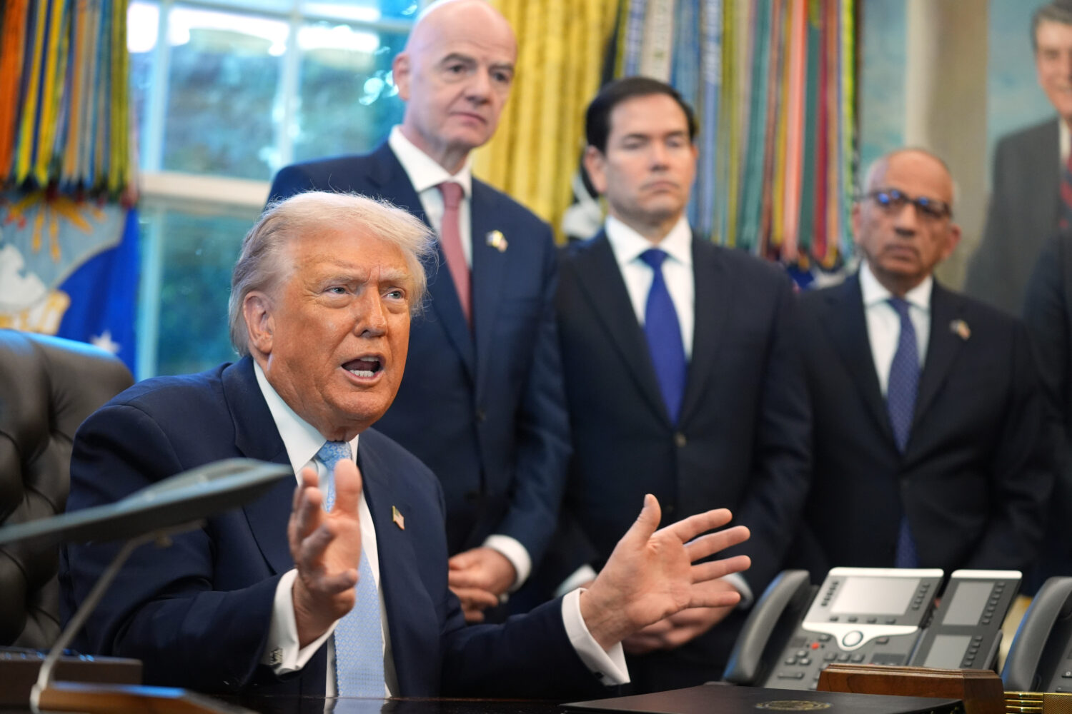 President Donald Trump answers questions from reporters during a meeting with the White House task ...
