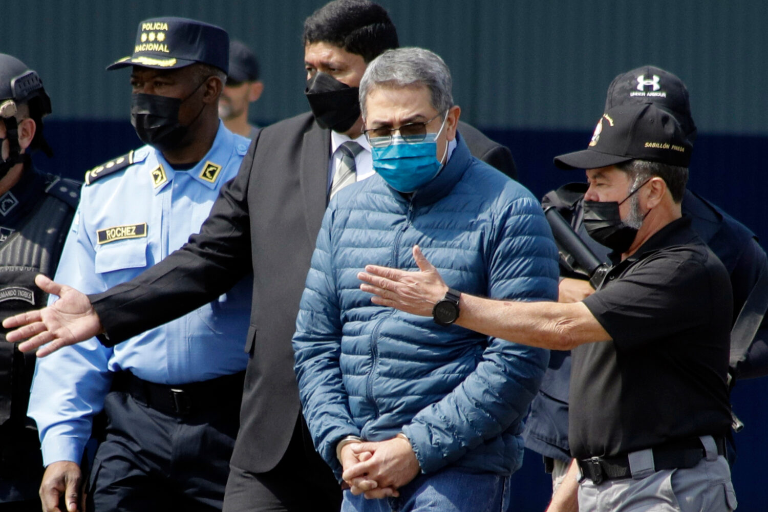 FILE - Former Honduran President Juan Orlando Hernandez, second from right, is taken in handcuffs t...