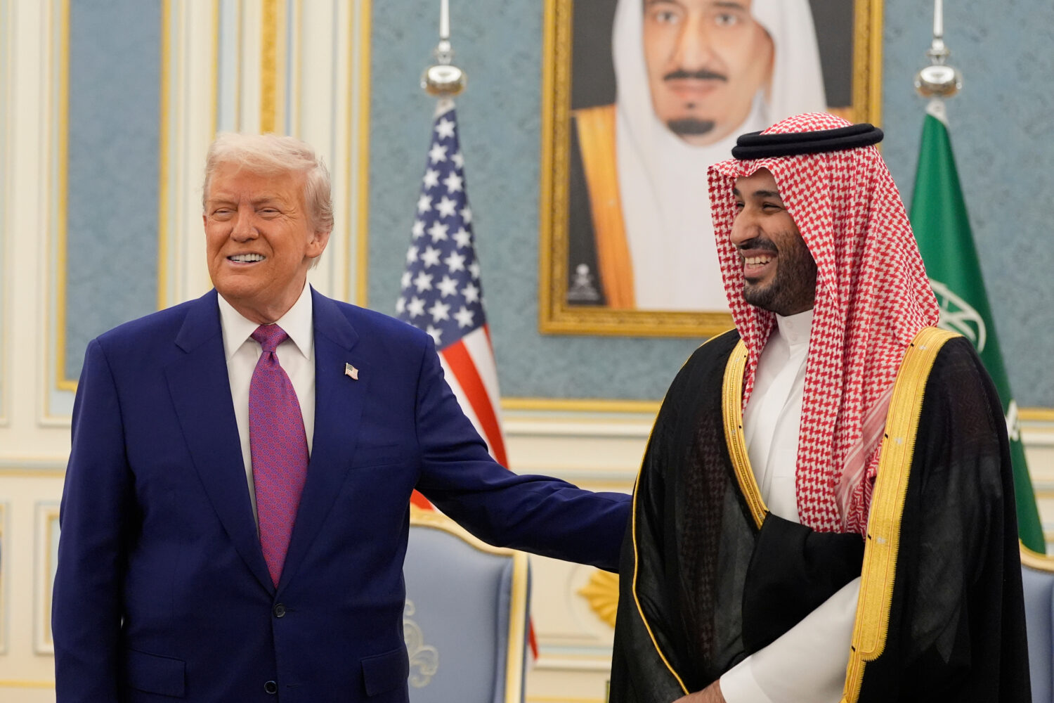 FILE - President Donald Trump and Saudi Crown Prince Mohammed bin Salman gesture as they meet deleg...
