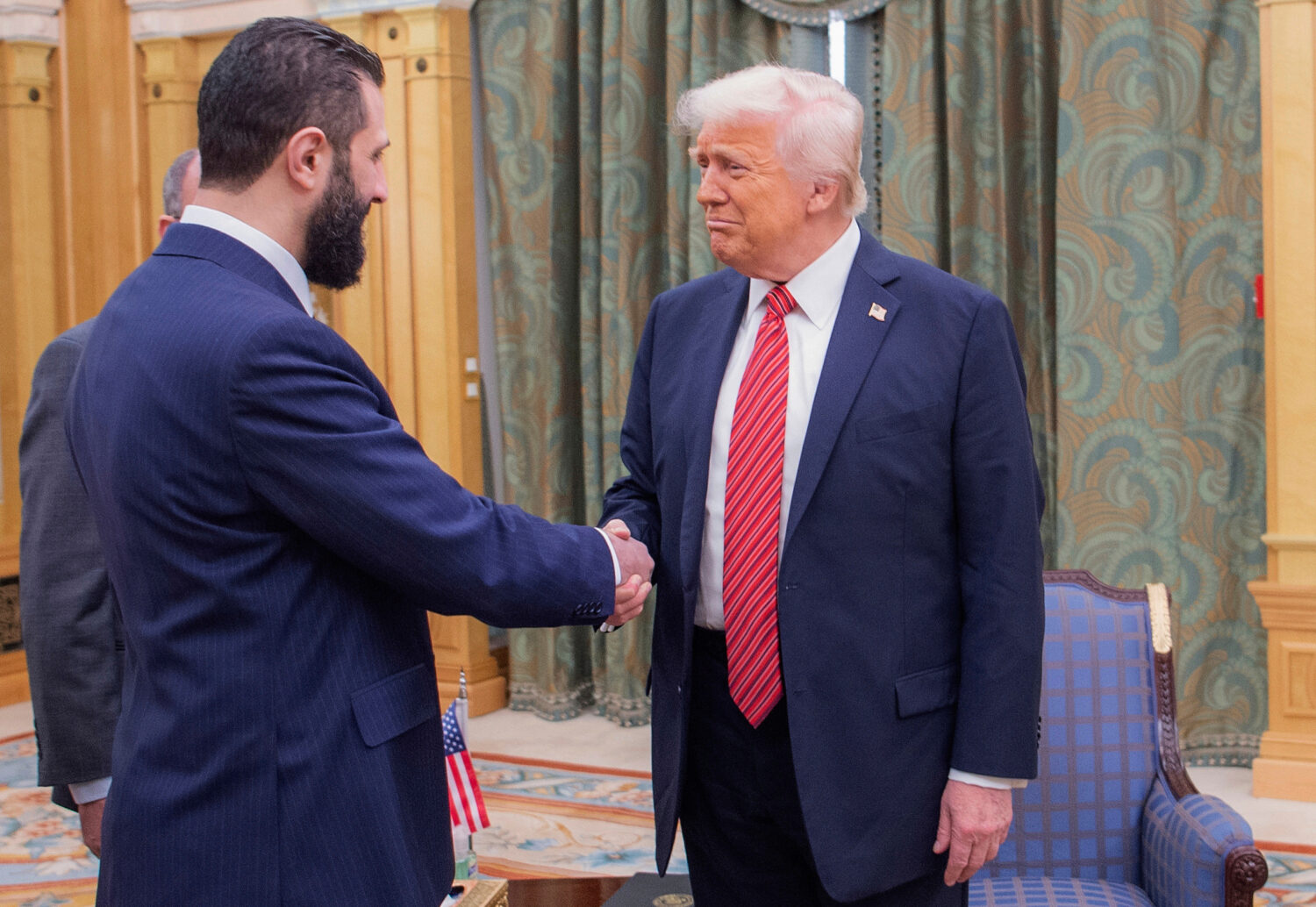 In this photo released by the Saudi Royal Palace, President Donald Trump, right, shakes hands with ...