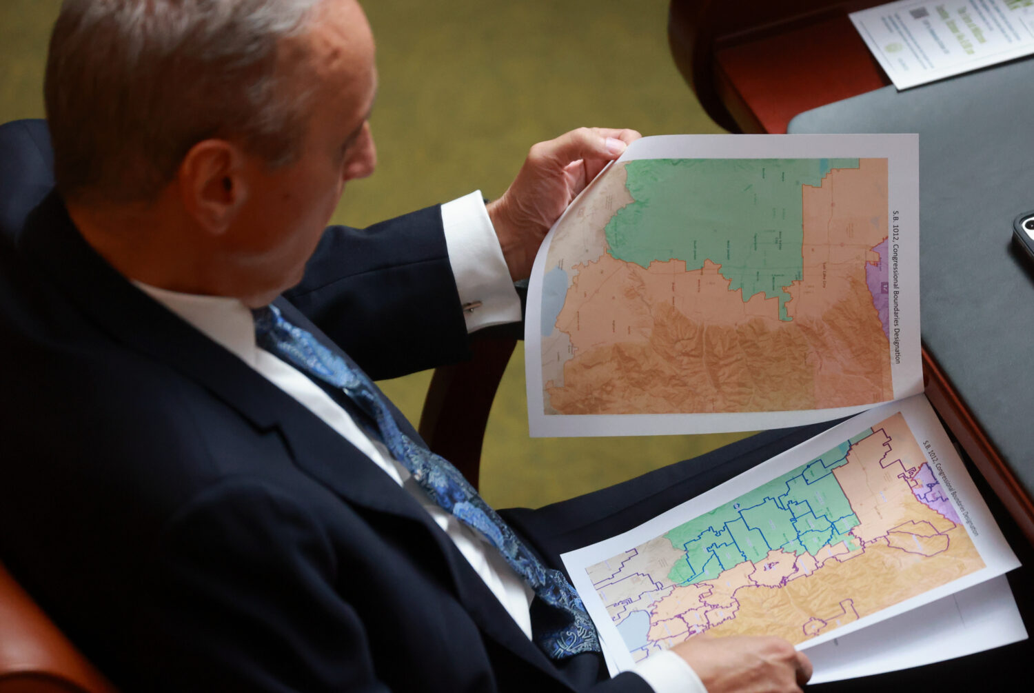 FILE -Rep. Cory Maloy, R-Lehi, holds a packet of potential redistricting maps as SB1012 Congression...