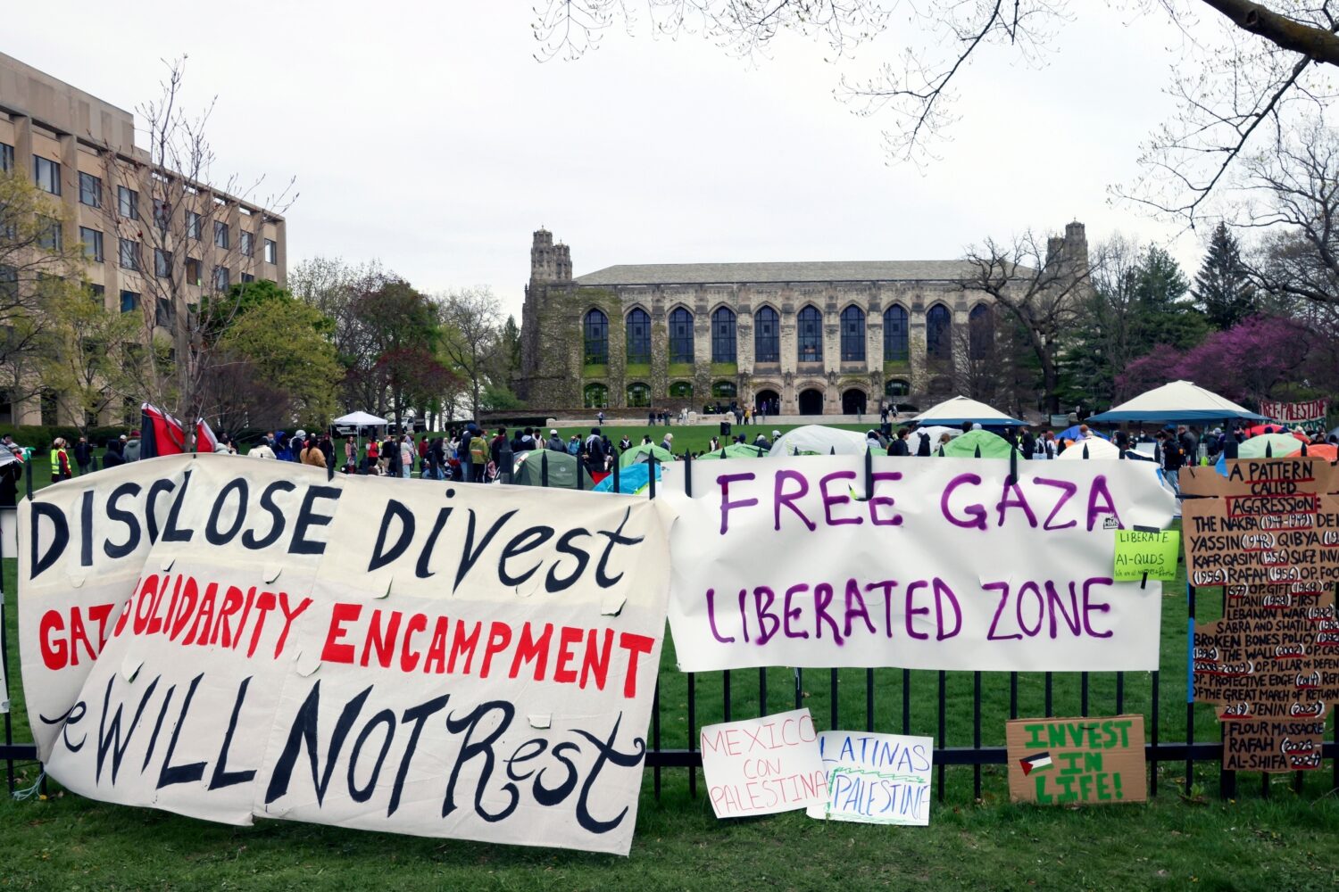 FILE - Signs are displayed outside a tent encampment at Northwestern University on April 26, 2024, ...
