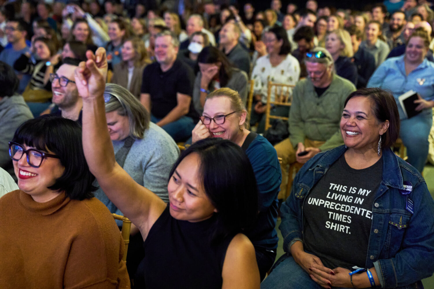 Micaela Mejia Pond, right, and other attendees of Crooked Con, cheer while listening to Sen. Ruben ...