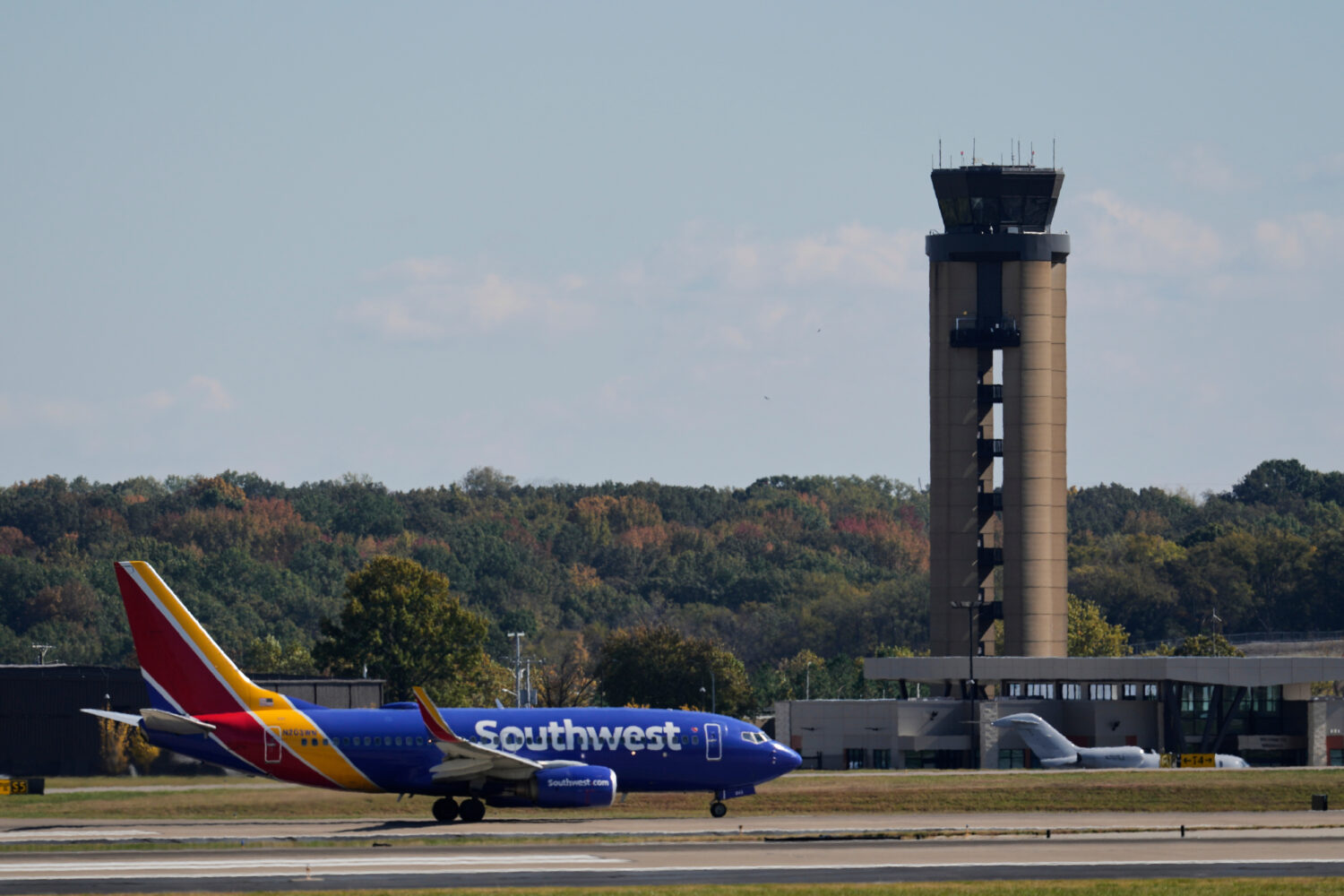 A plane taxis past the control tower before takeoff at the Nashville International Airport, Friday,...
