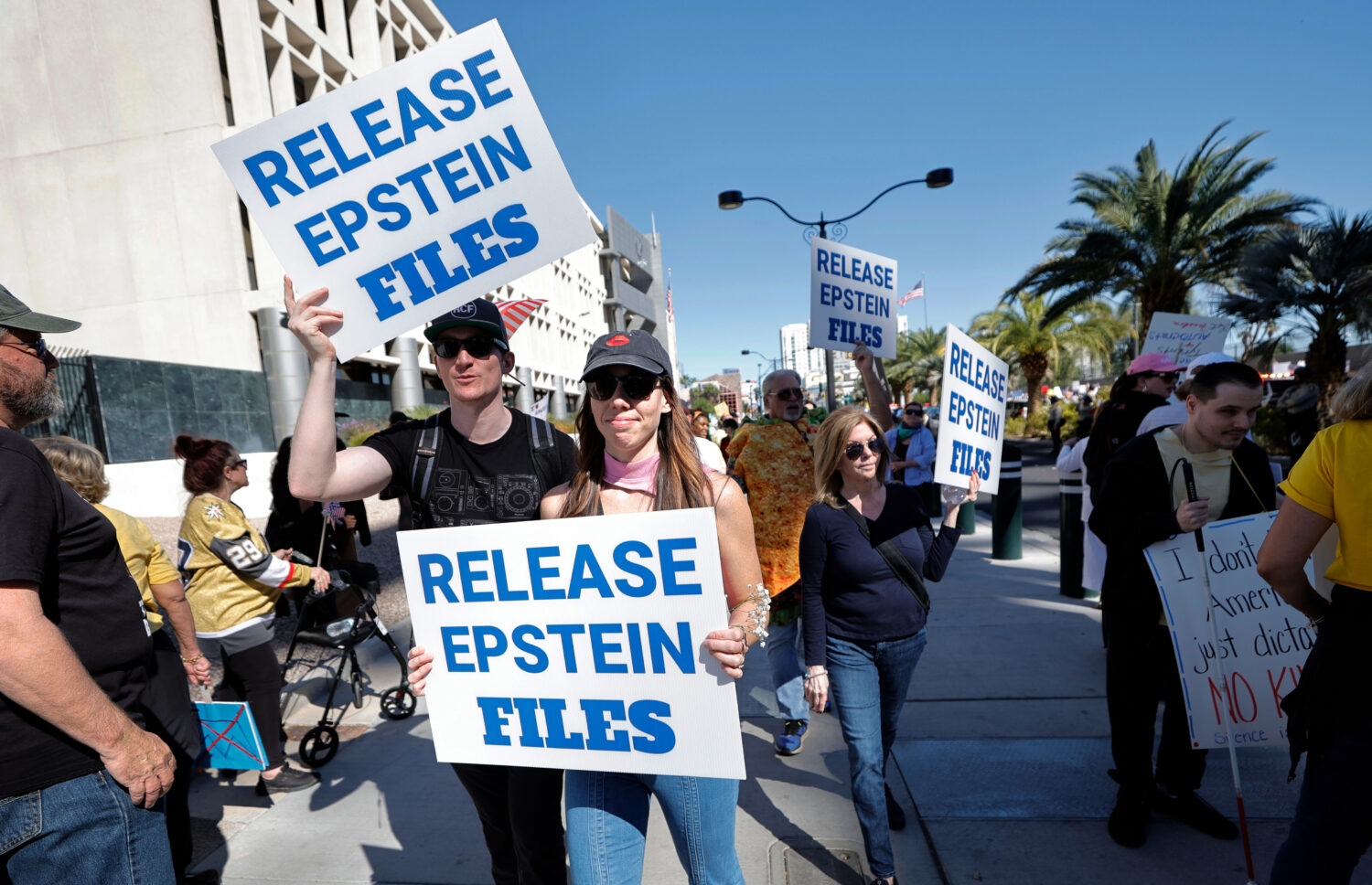 Demonstrators hold signs asking for the release of the Epstein files during a "No Kings" protest in...
