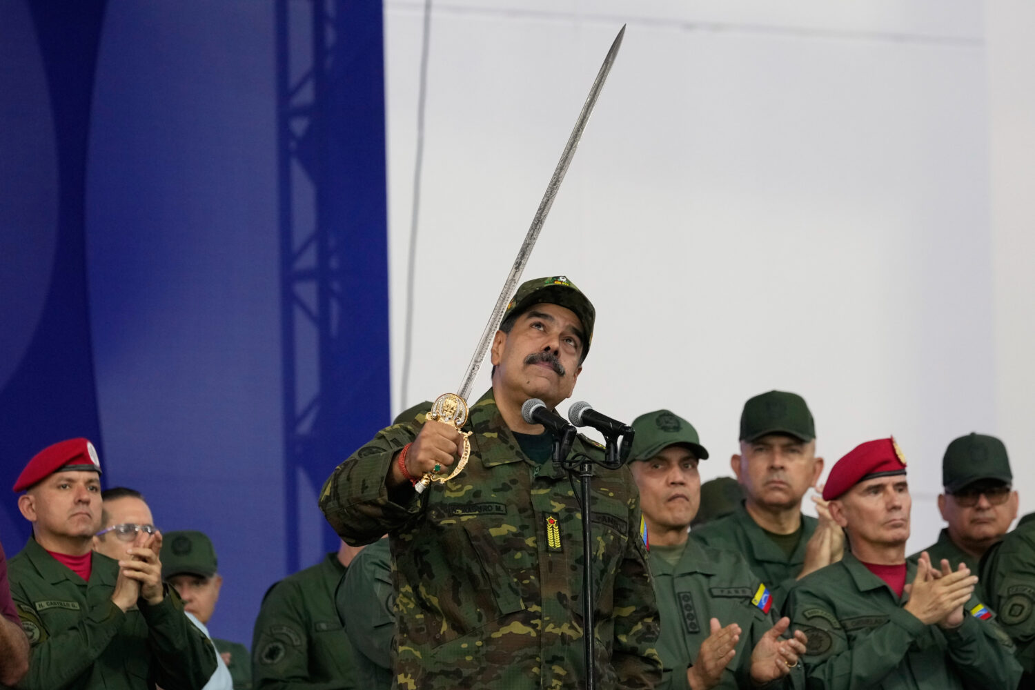 Venezuelan President Nicolas Maduro brandishes a sword said to have belonged to independence hero S...