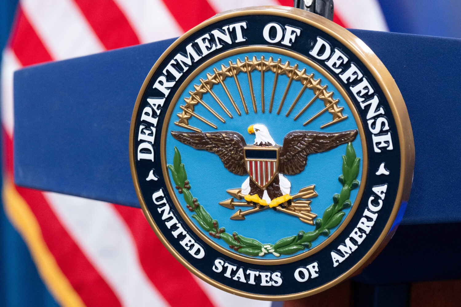 FILE - The Department of Defense seal is seen on the podium in the Press Briefing room at the Penta...