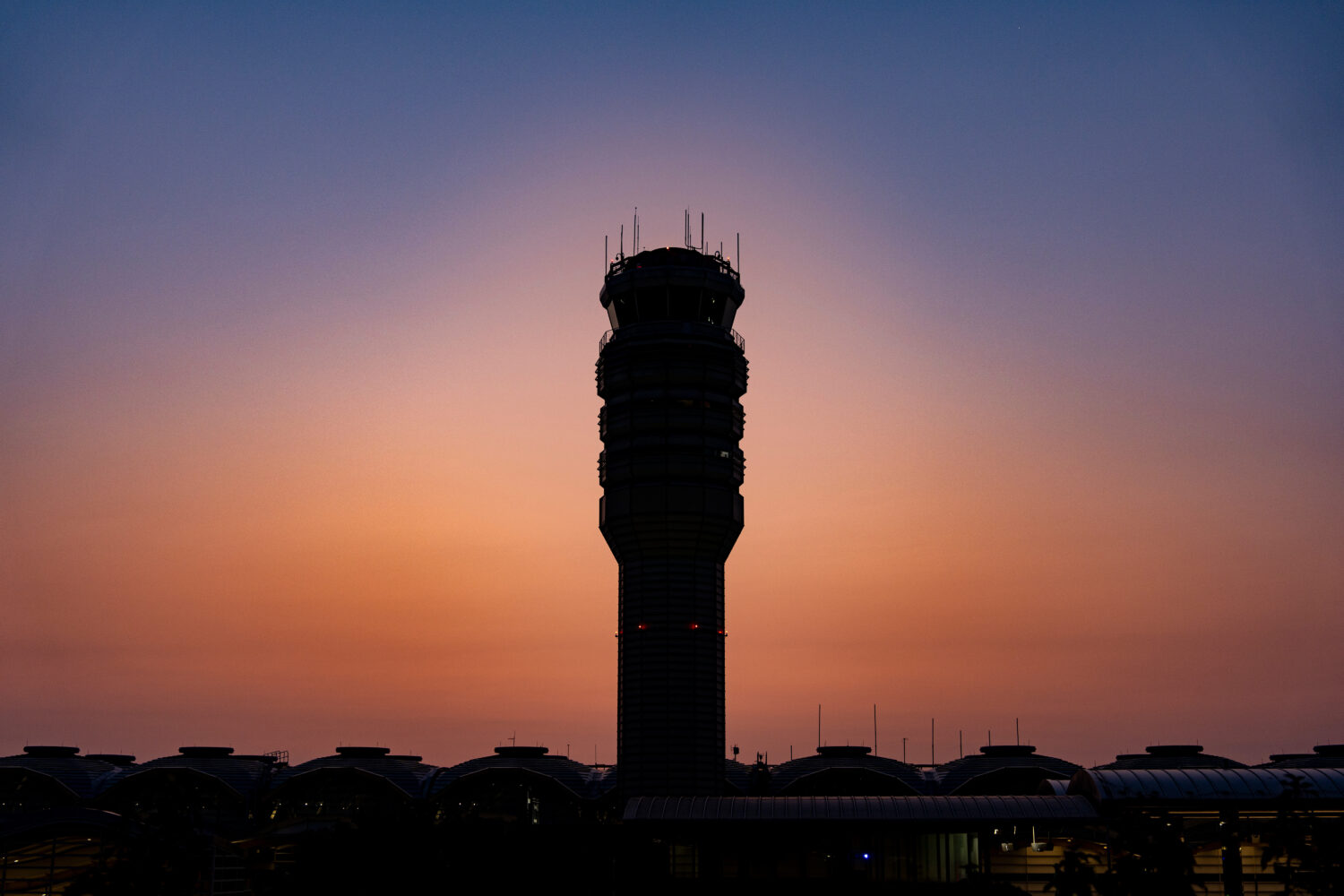 FILE - The control tower for Ronald Reagan Washington National Airport is seen at sunrise on Aug. 8...