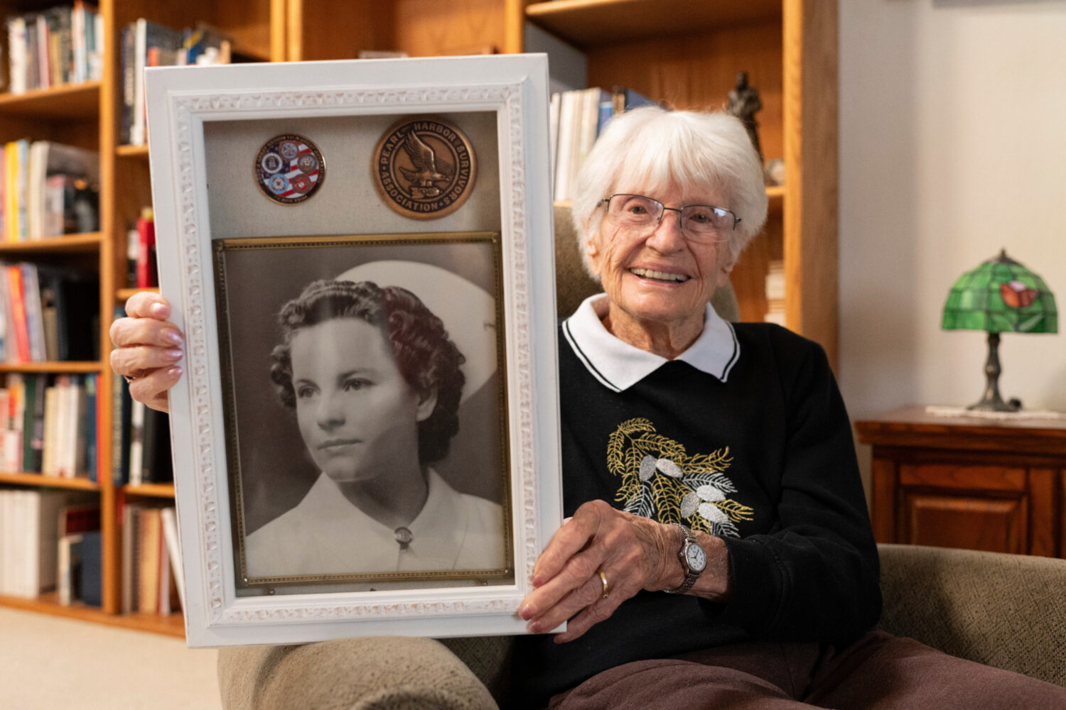 Alice Darrow shows a photo of herself from when she was a nurse during World War II, Thursday, Oct....