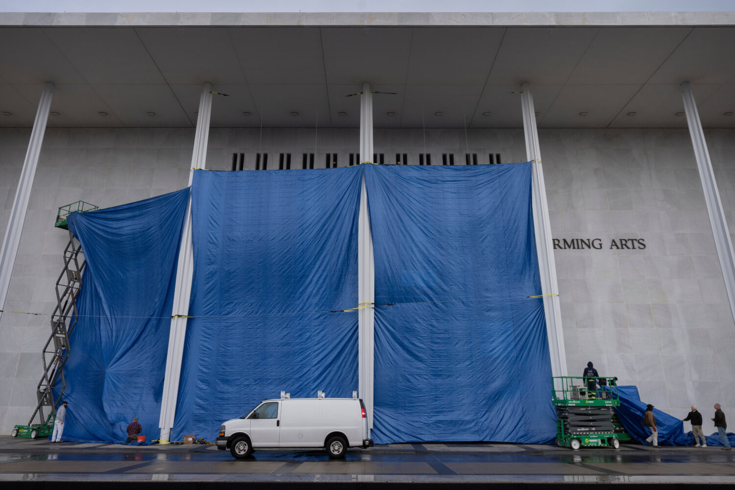 Tarps are installed in front of the sign on the Kennedy Center on Friday, Dec. 19, 2025, in Washing...