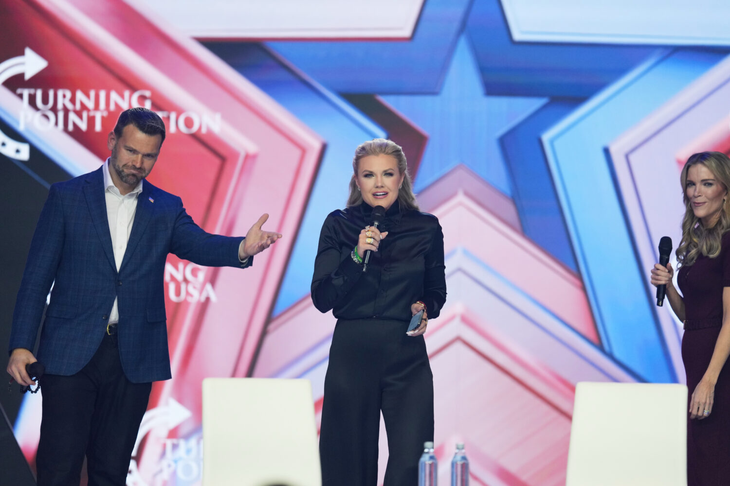 Erika Kirk, center, speaks as Jack Posobiec, left, and Megyn Kelly look on during Turning Point USA...