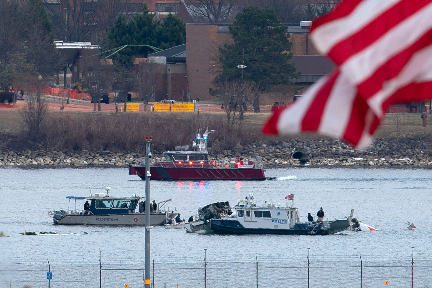 FILE - A diving team and police boat is seen near a wreckage site in the Potomac River, from Ronald...