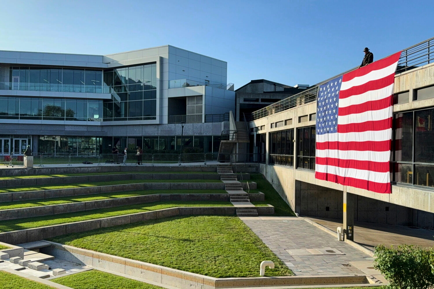 FILE - A national flag hangs over the site where conservative activist Charlie Kirk was shot and ki...