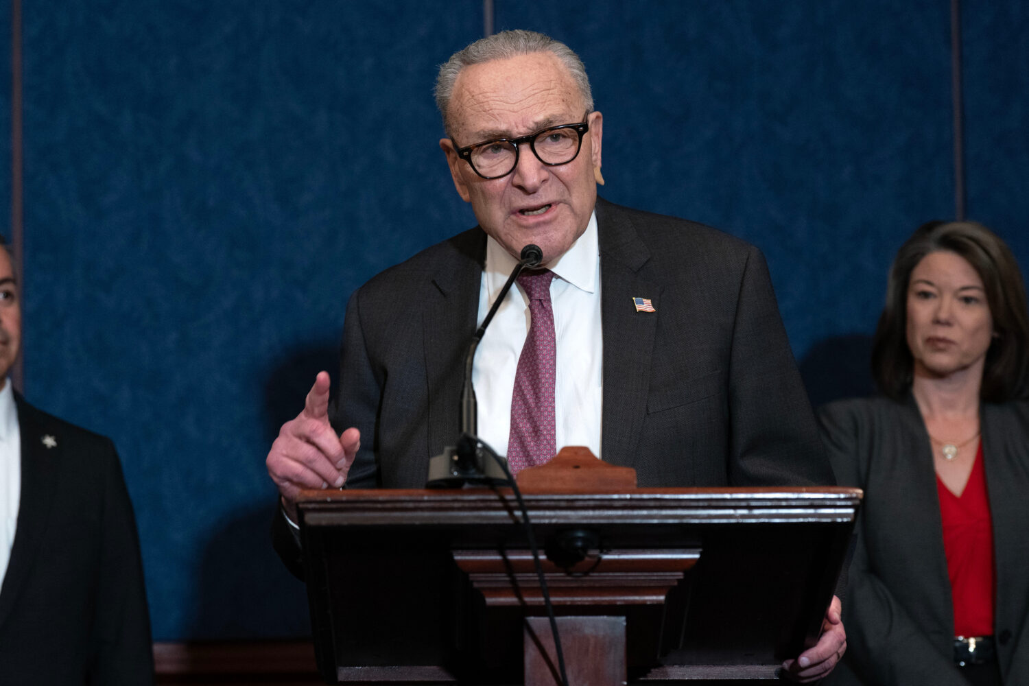 Senate Minority Leader Chuck Schumer, D-N.Y., flanked by Rep. Angie Craig, D-Minn., right, speaks d...