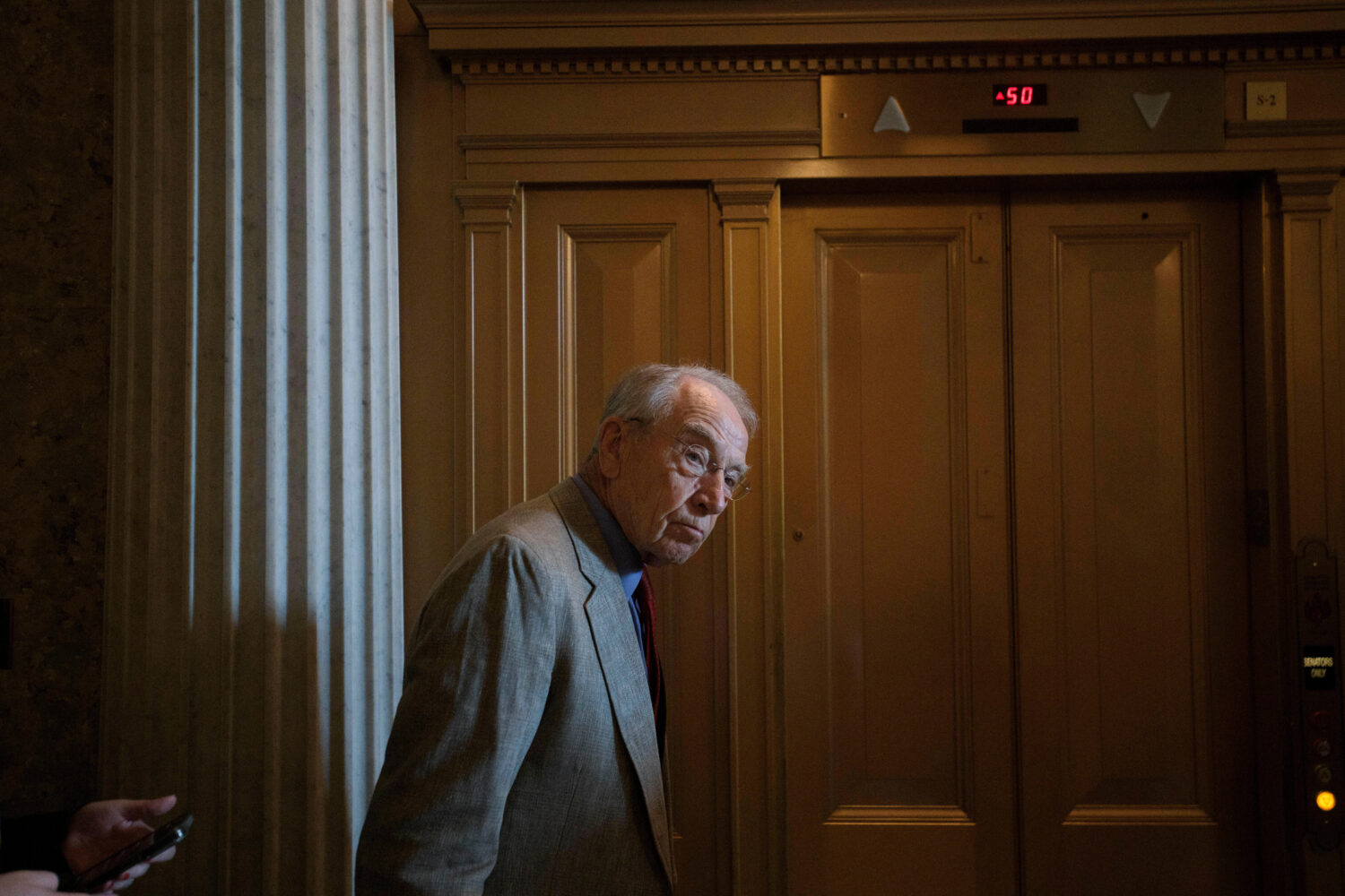 FILE - Sen. Chuck Grassley, R-Iowa, walks from the Senate chamber as Senate Republicans vote on Pre...