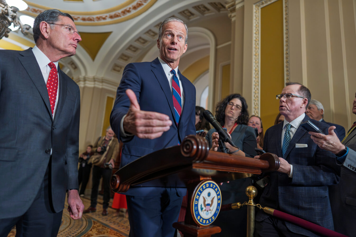 Senate Majority Leader John Thune, R-S.D., joined at left by Sen. John Barrasso, R-Wyo., speaks to ...