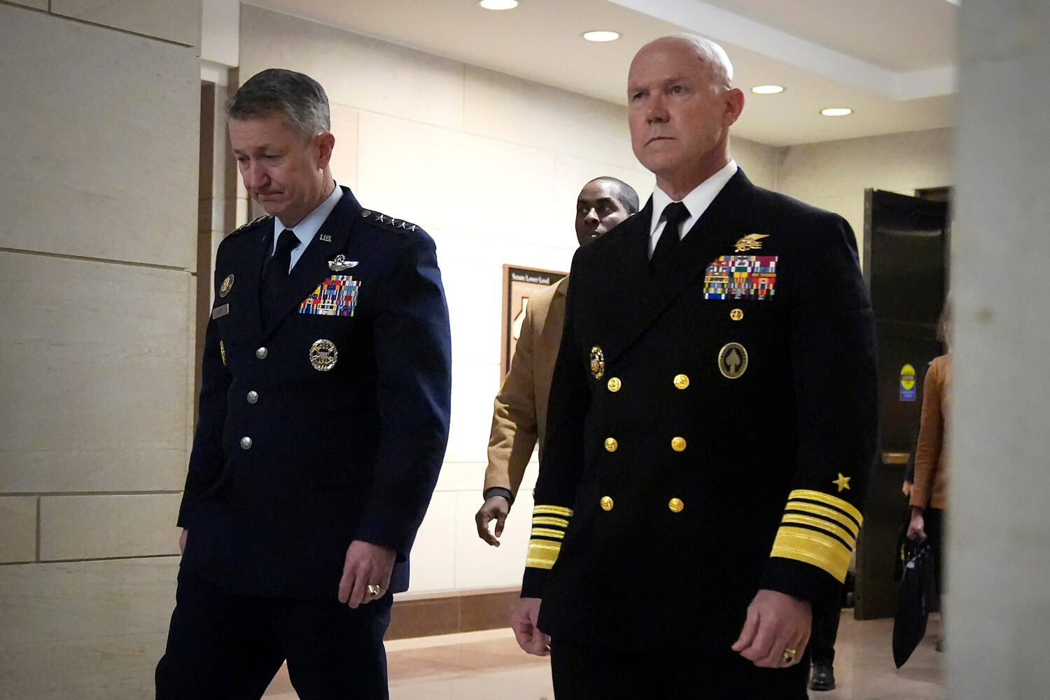 U.S. Navy Adm. Frank M. Bradley, right, accompanied by Gen. Dan Caine, chairman of the Joint Chiefs...
