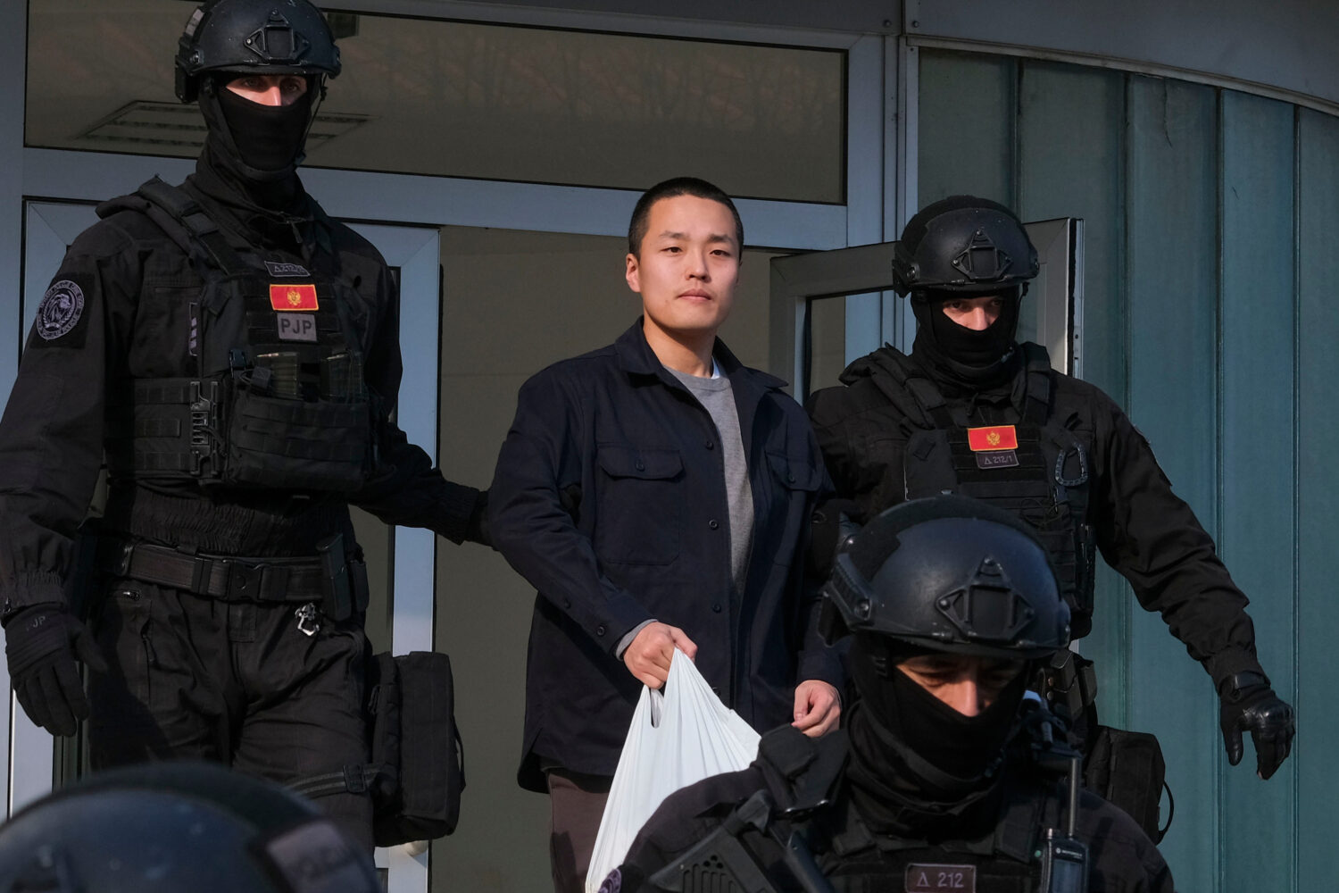 FILE - Montenegrin police officers escort South Korean citizen, Terraform Labs founder Do Kwon in M...