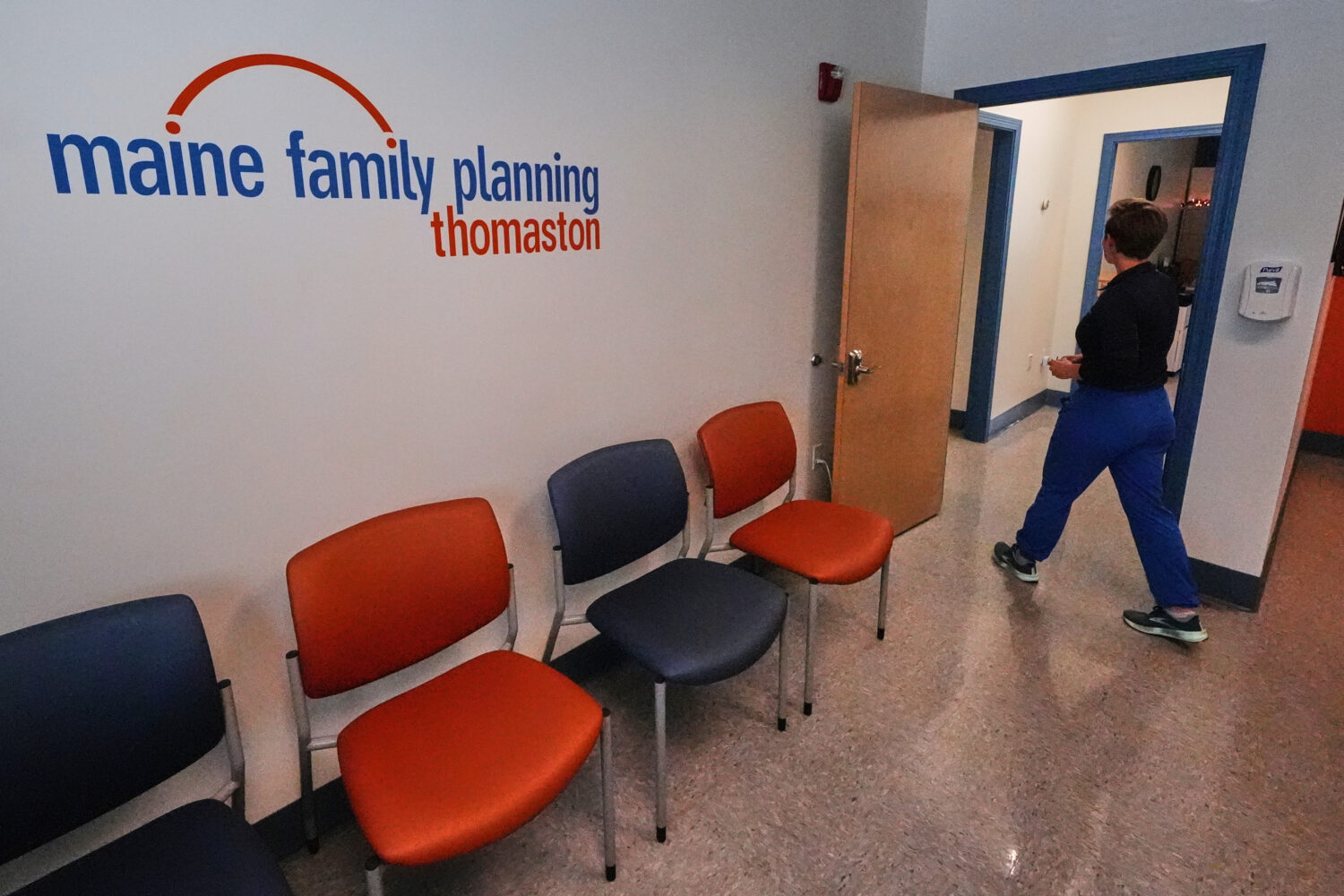 FILE - Vanessa Shields-Haas, a nurse practitioner, walks from the lobby toward the examination room...