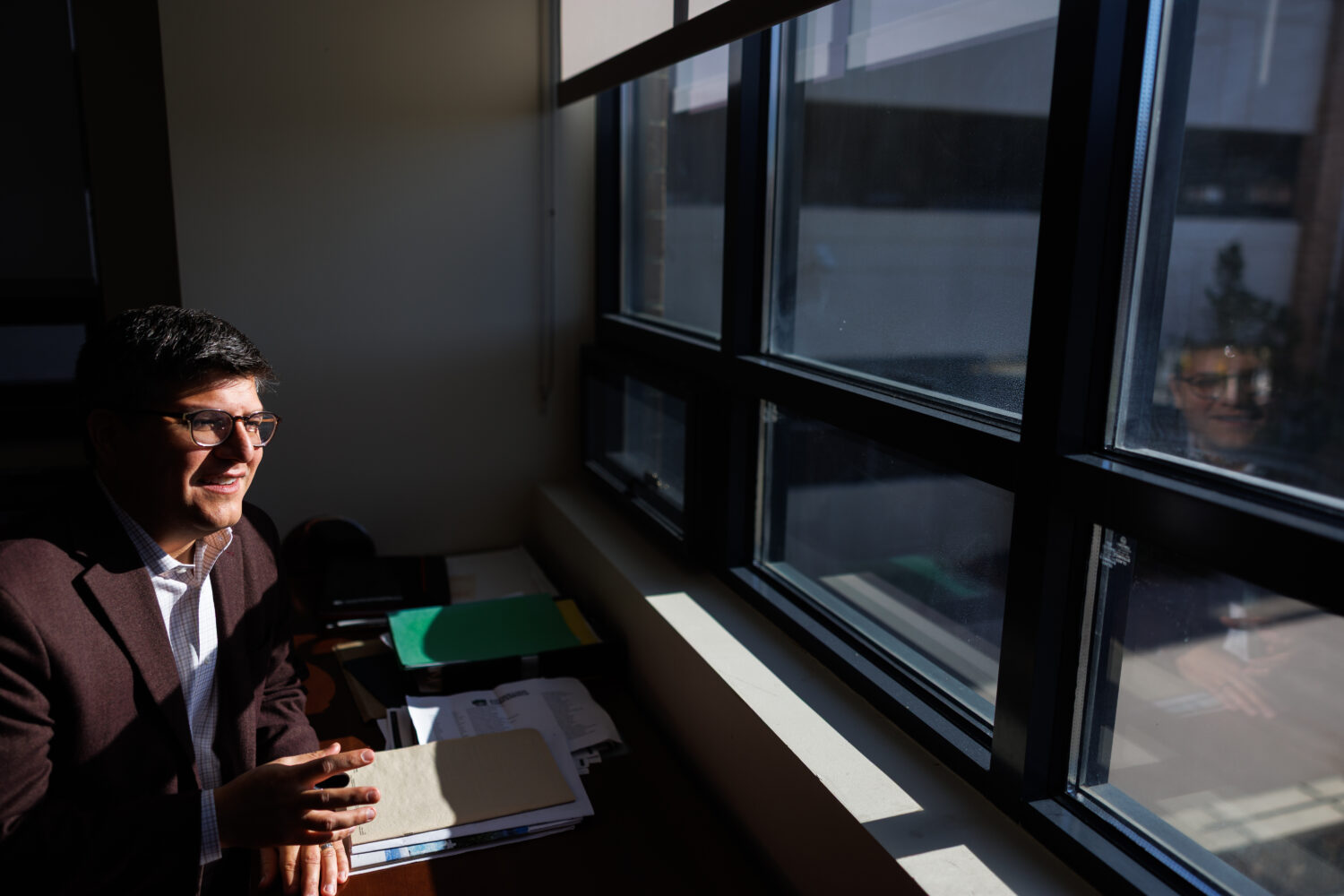 Juan Espinoza, vice provost for enrollment management at Virginia Tech, poses for a photo in his of...