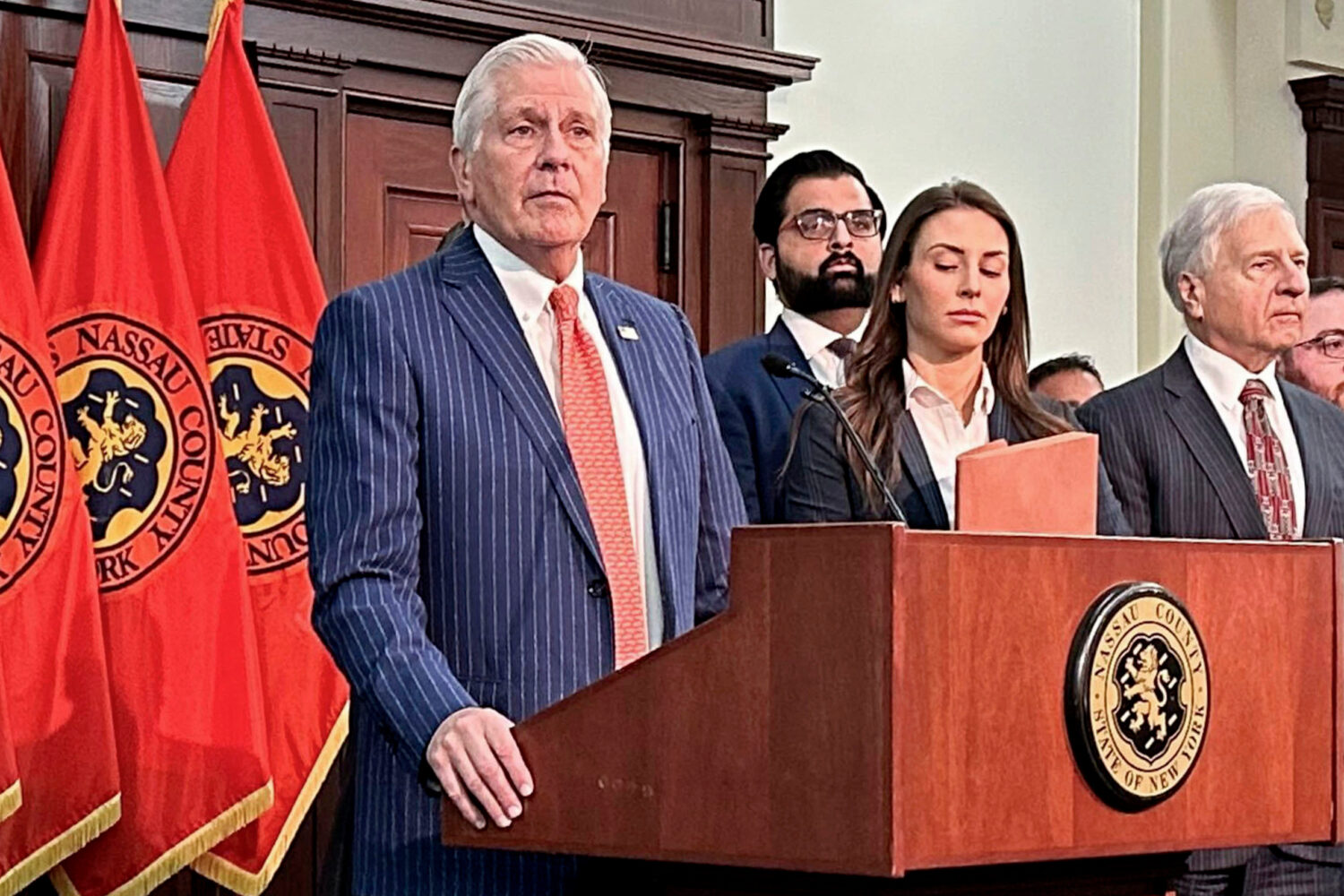 FILE - Nassau County Executive Bruce Blakeman, at podium, speaks during a news conference in Mineol...