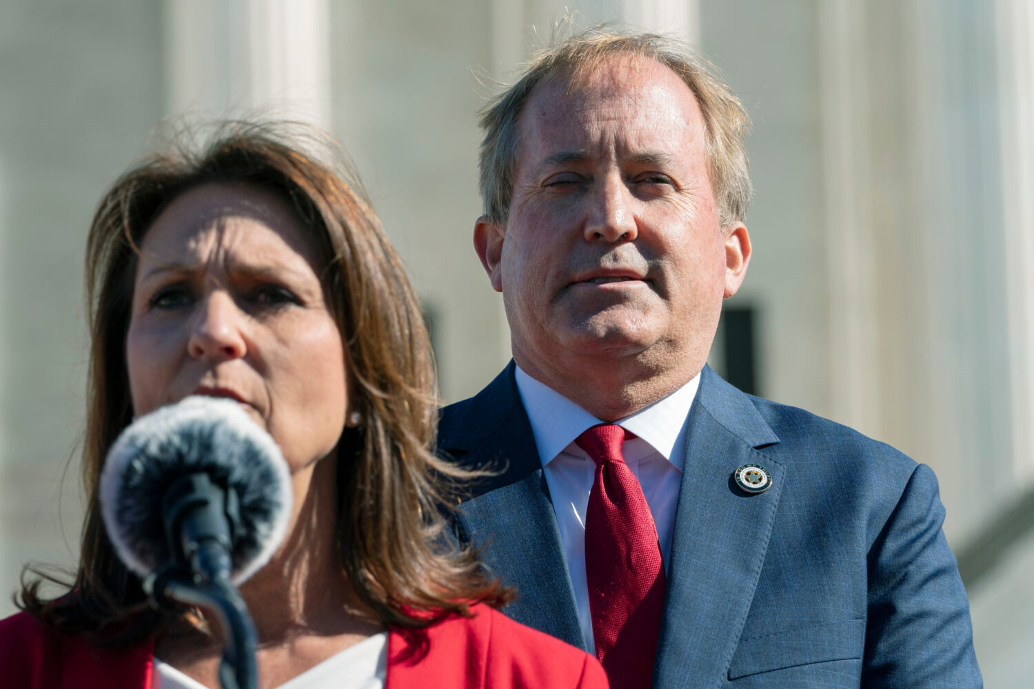 FILE - Texas Attorney General Ken Paxton, right, listens as his wife, Texas State Sen. Angela Paxto...