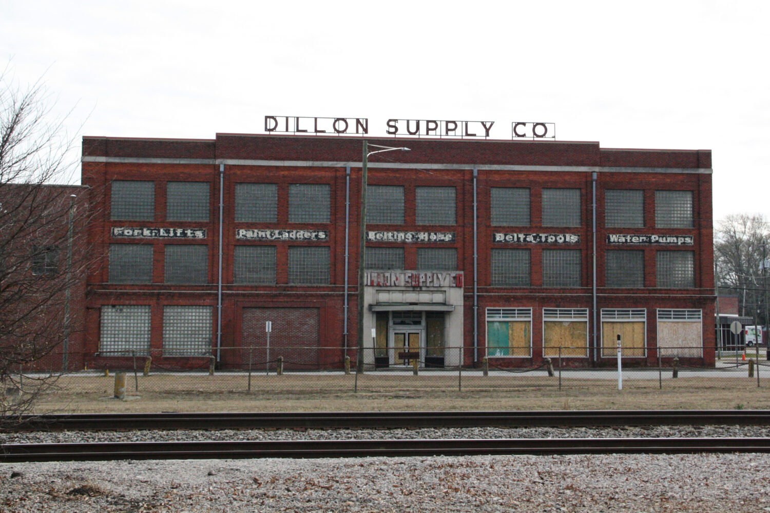 Railroad tracks cut through downtown Rocky Mount, N.C., Thursday, Dec. 18, 2025, with a boarded up ...