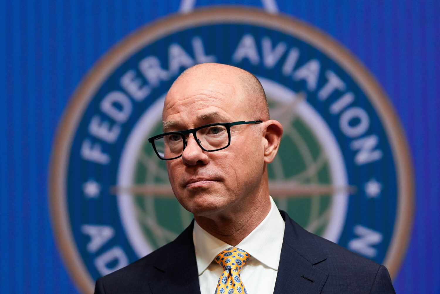 FILE - Federal Aviation Administration administrator Bryan Bedford looks on as Transportation Secre...
