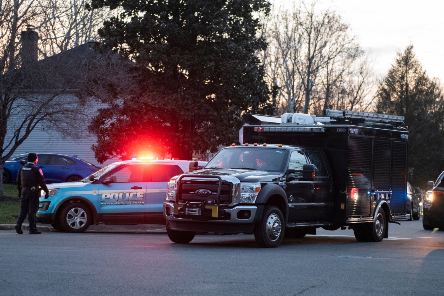 An FBI truck departs the street where the FBI made an arrest and are investigating a house in Woodb...