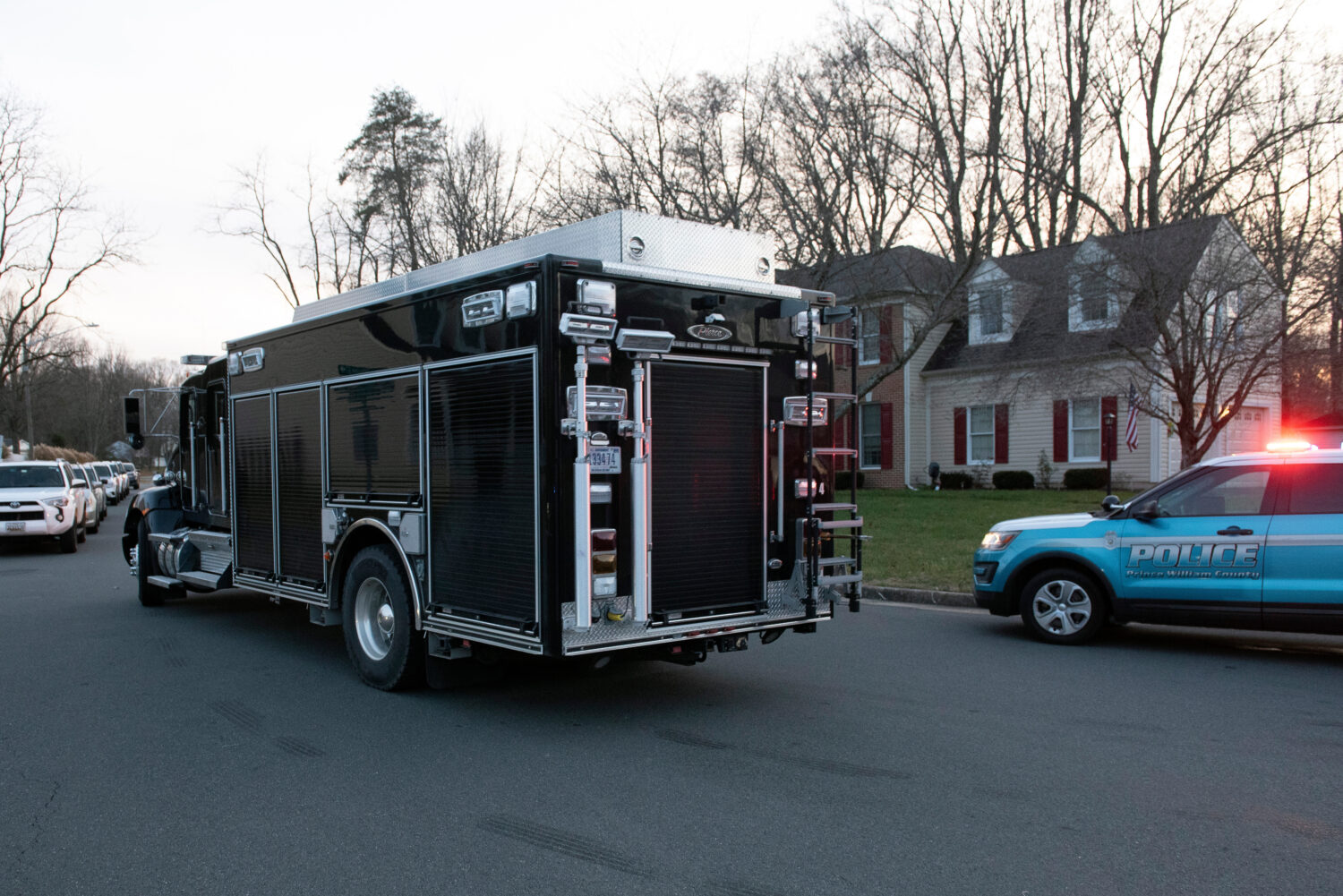 An FBI truck departs the street where the FBI made an arrest and are investigating a house in Woodb...