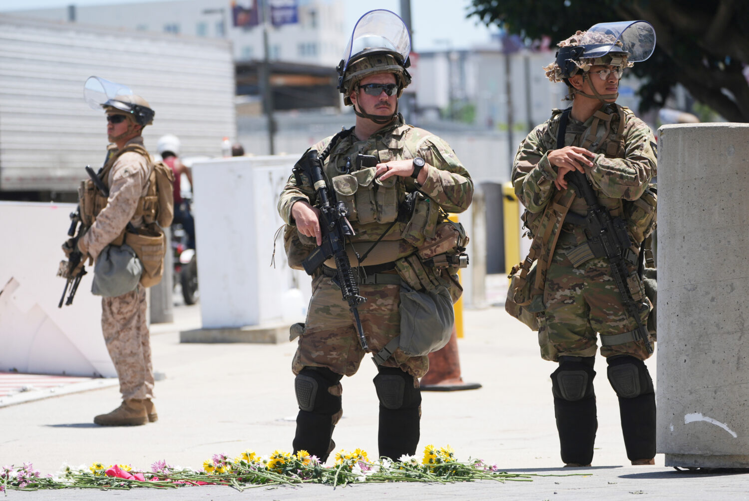 FILE - Members of the California National Guard and U.S. Marines guard a federal building on Tuesda...