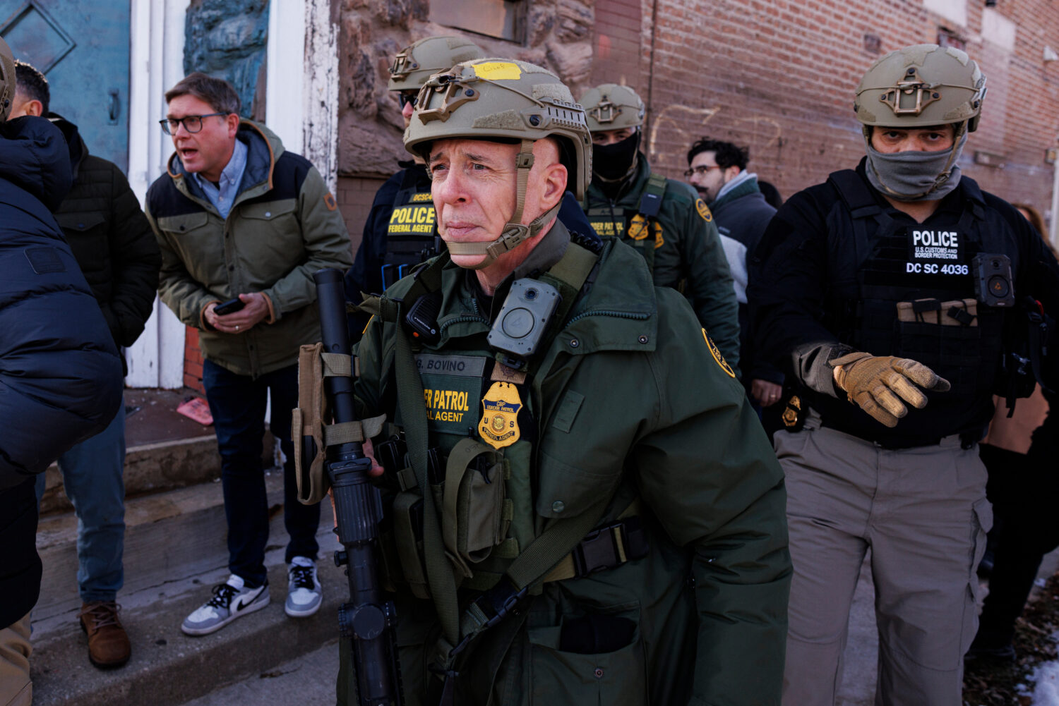 Border Patrol Cmdr. Gregory Bovino walks alongside his agents after they detain an individual near ...