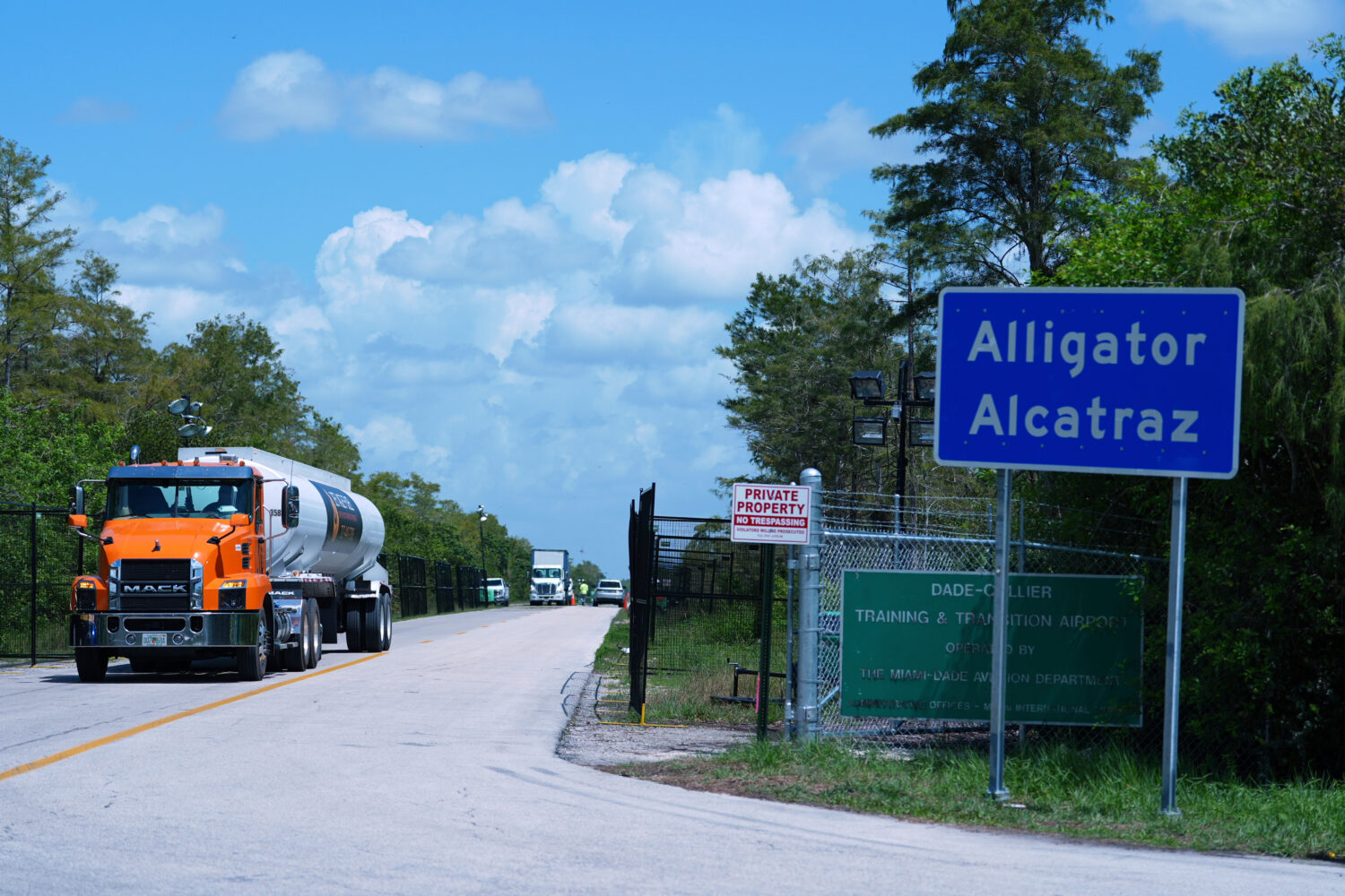 FILE - Trucks come and go from the "Alligator Alcatraz" immigration detention center in the Florida...