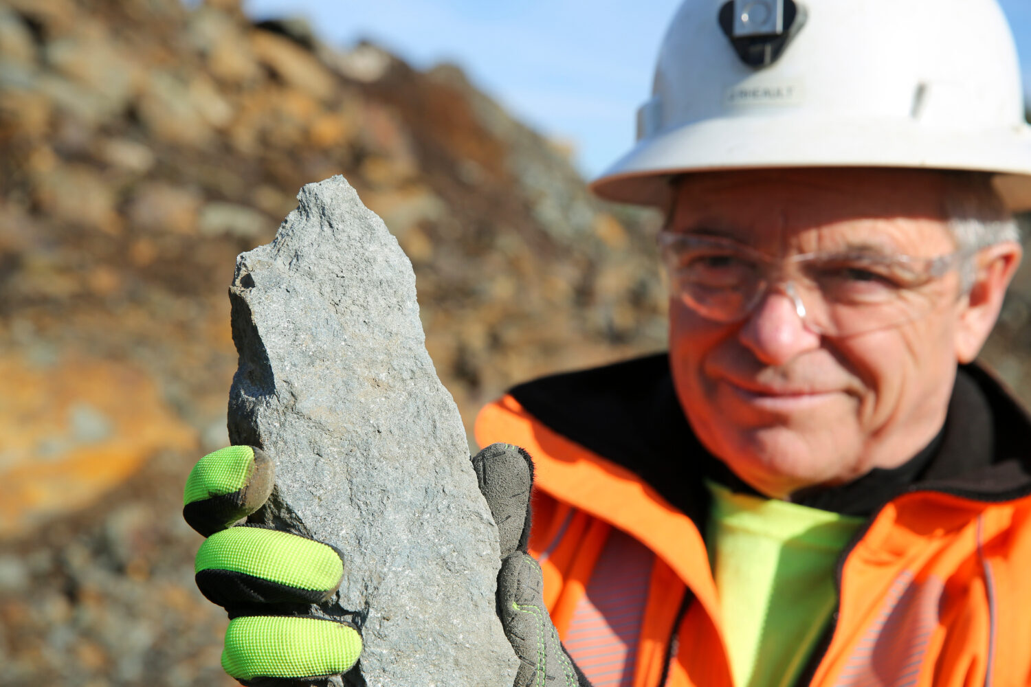 Joel Rheault, vice president of operations for Titan Mining Corp., holds a rock containing graphite...