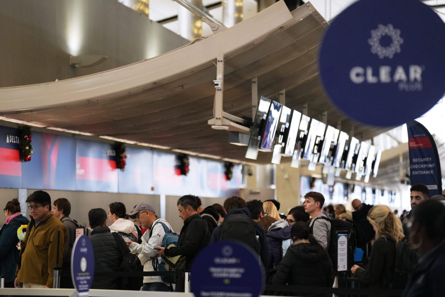 Travelers wait in a TSA checkpoint at Detroit Metropolitan Wayne County Airport Wednesday, Nov. 26,...