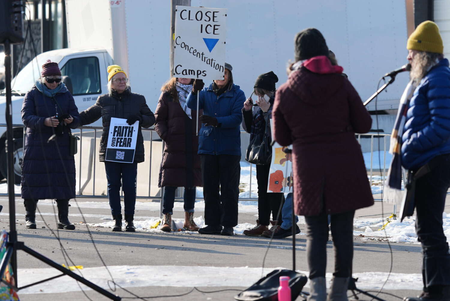 Protesters gather as Law enforcement officers guard outside an ICE processing facility in the Chica...
