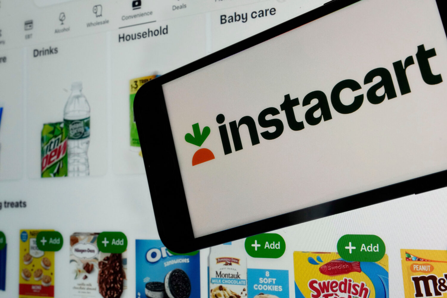 FILE - An instacart logo and an instacart webpage are seen in New York, Sept. 6, 2023. (AP Photo/Ri...