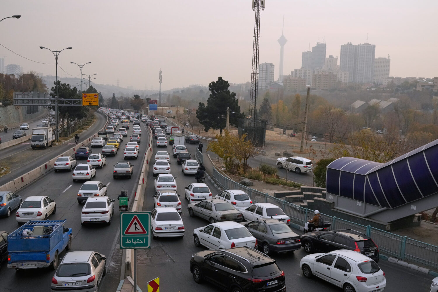 Cars drive in an afternoon traffic jam in a high air pollution in Tehran, Iran, Sunday, Dec. 7, 202...