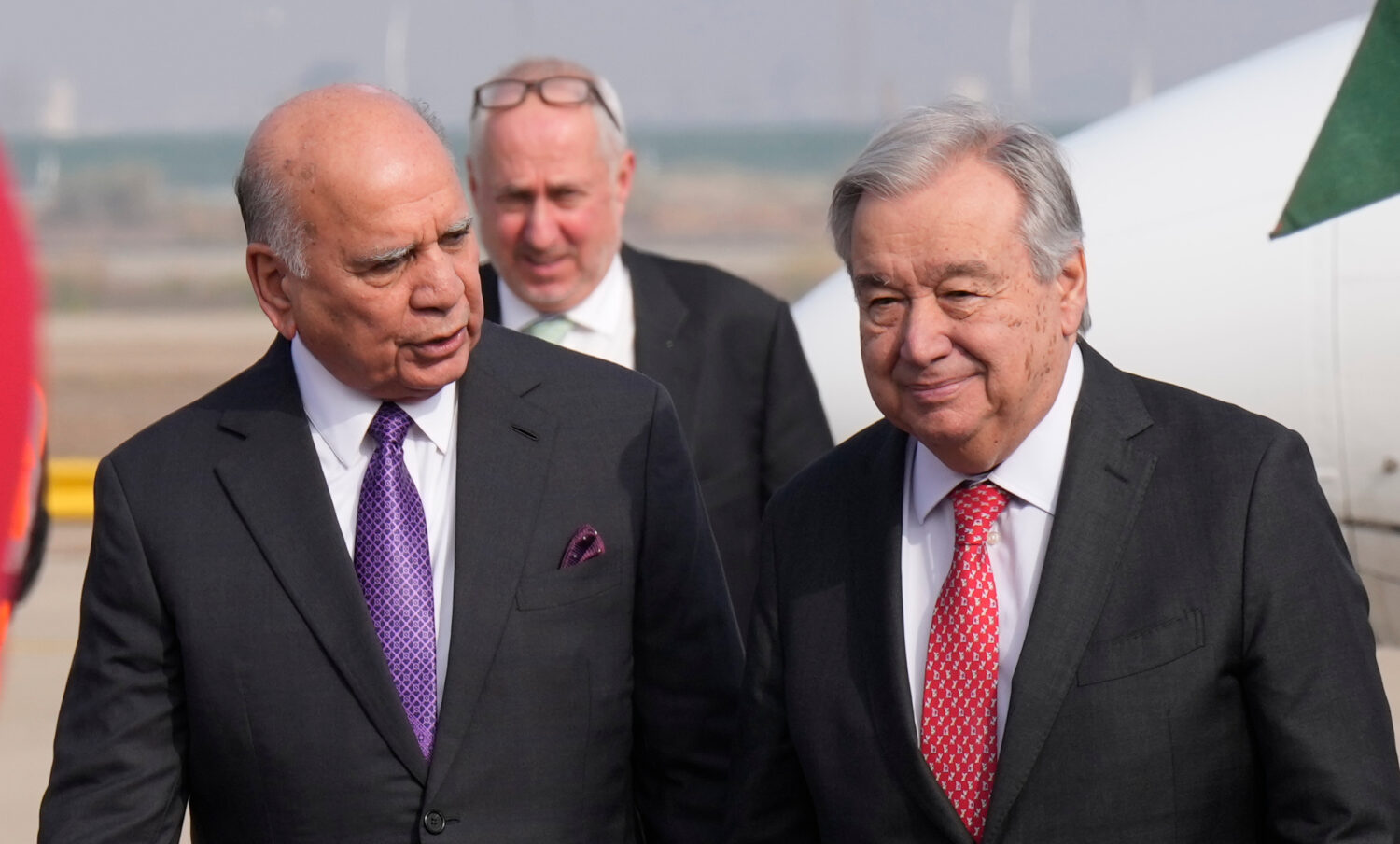 Iraqi Foreign Minister Fouad Hussein, left, greets United Nations Secretary-General Antonio Guterre...