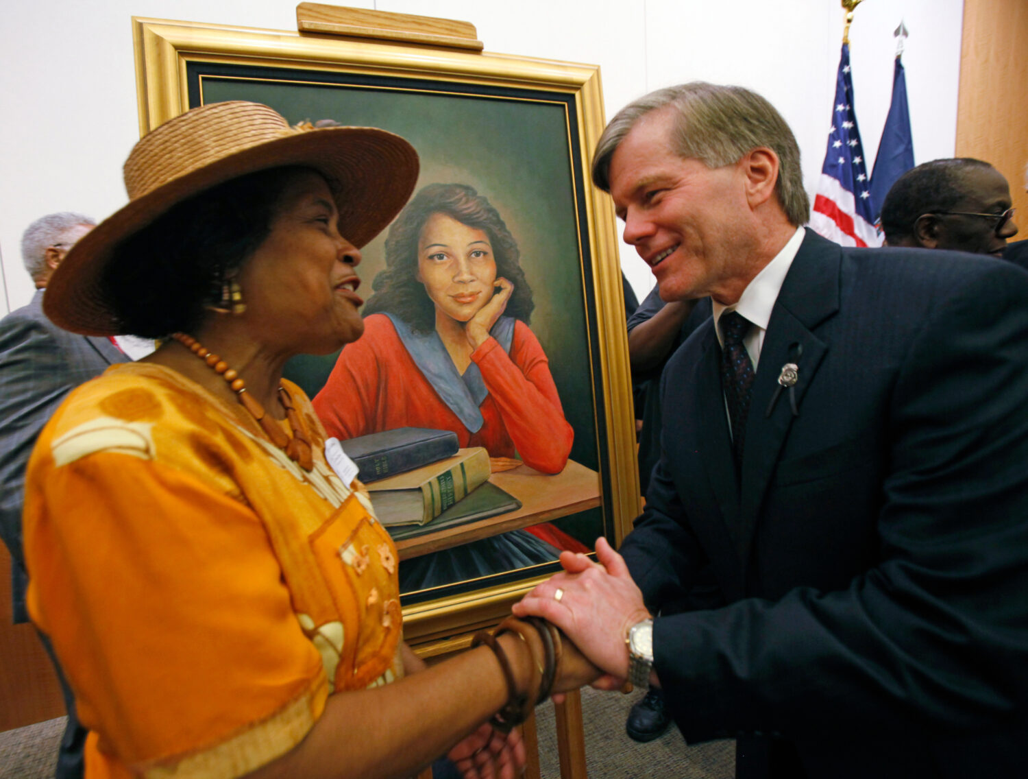FILE - Joan Cobbs, left, sister of civil rights legend Barbara Johns, shakes hands with Virginia Go...