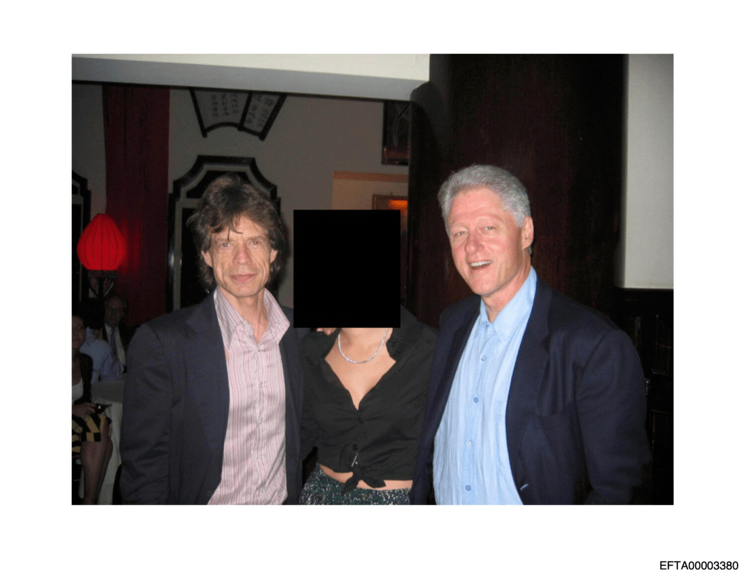 This undated, redacted photo released by the U.S. Department of Justice shows Mick Jagger, left, an...