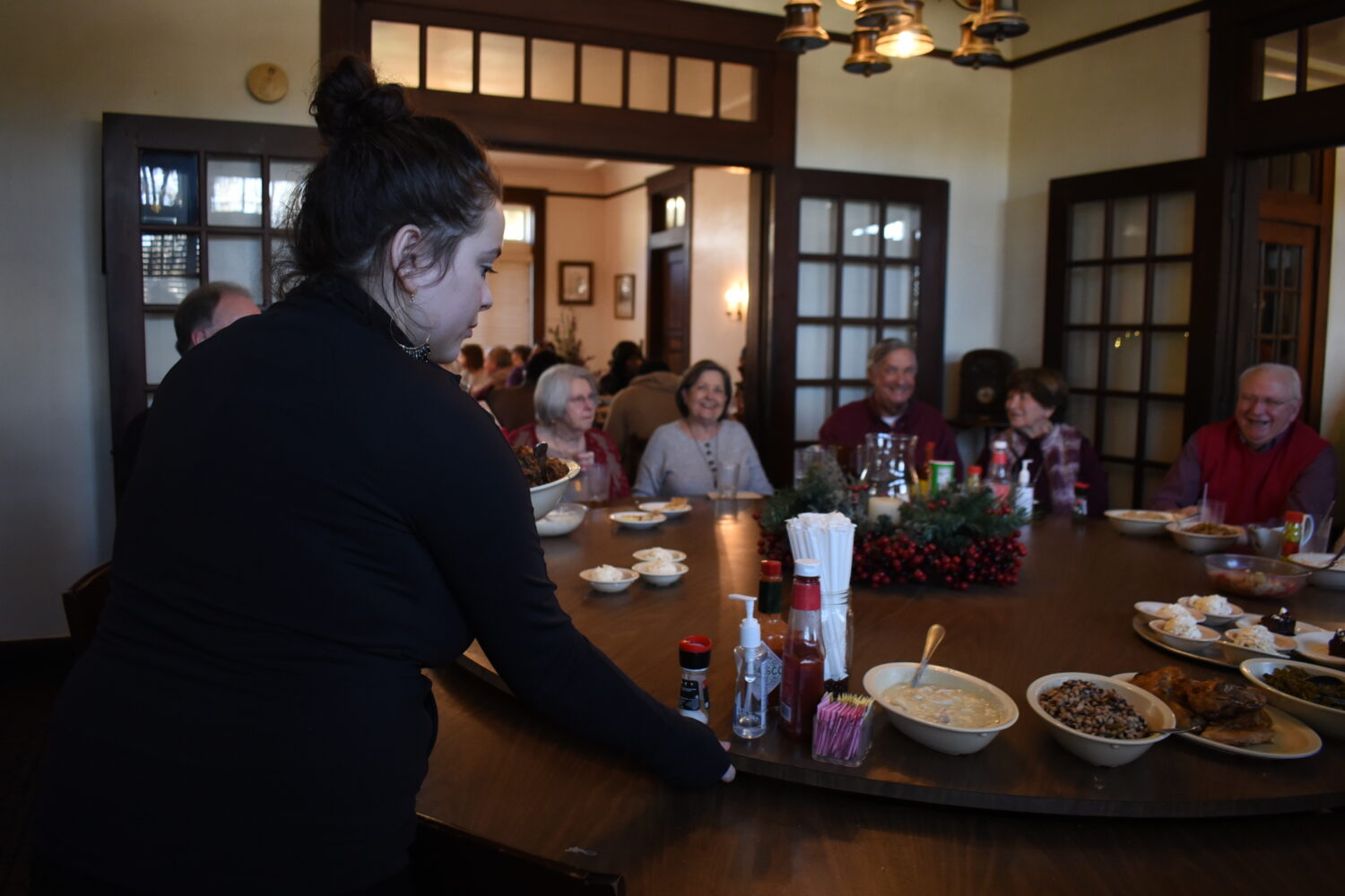 Lilli Johnson, a server at The Dinner Bell rotates a lazy Susan on Thursday, Dec. 11, 2025 in McCom...