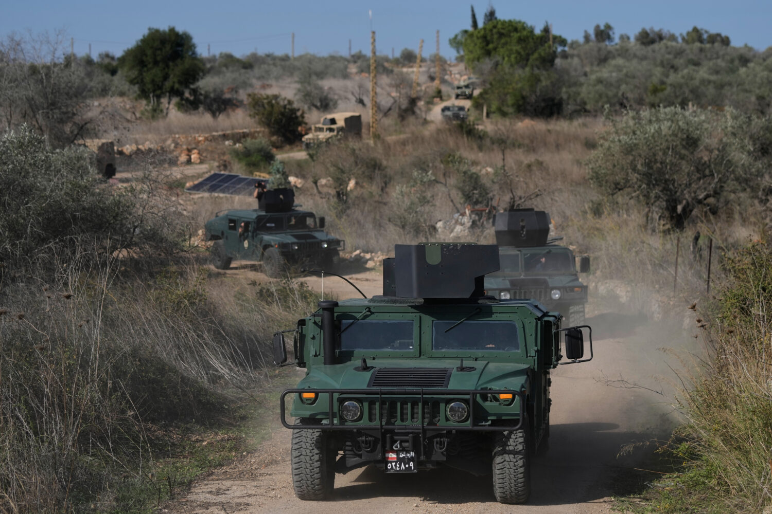 A convoy of Lebanese army vehicles drives near the border with Israel in the village of Alma al-Sha...