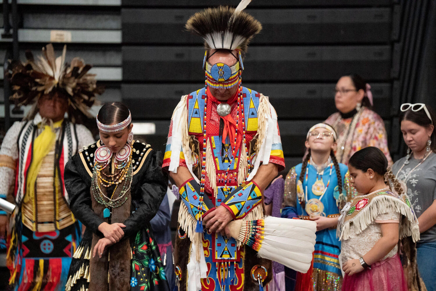 FILE - Members of the Lumbee Tribe bow their heads in prayer during the BraveNation Powwow and Gath...