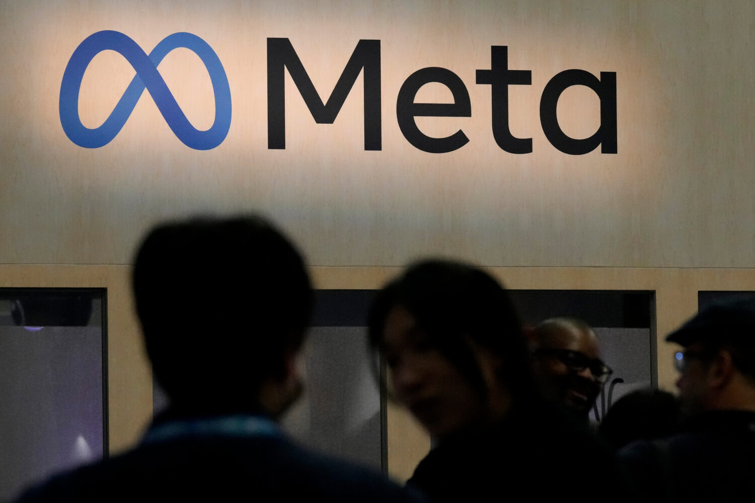 FILE - Attendees visit the Meta booth at the Game Developers Conference 2023 in San Francisco on Ma...