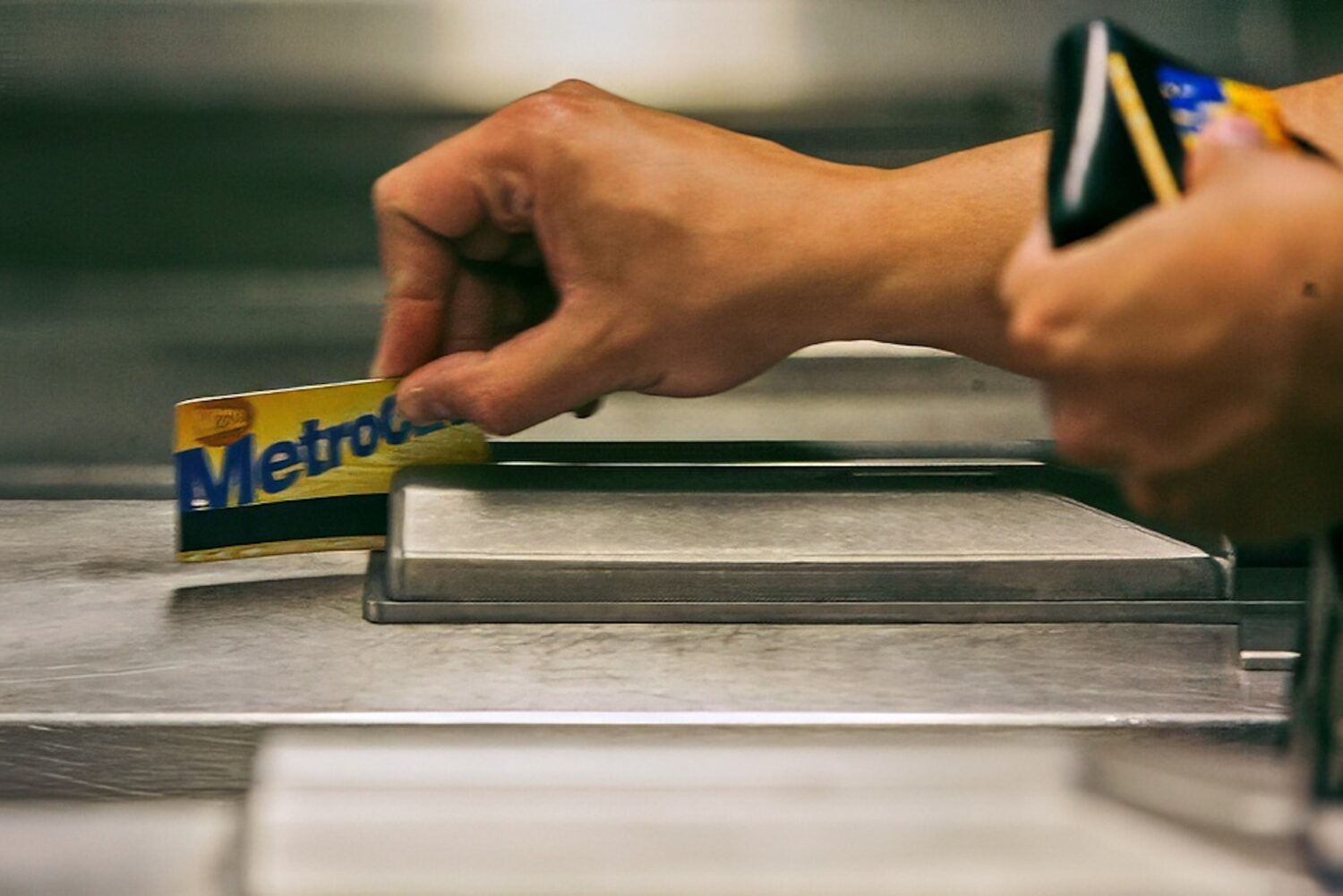FILE - A subway rider swipes his MetroCard in a turnstile as he enters the 34th St. subway station,...